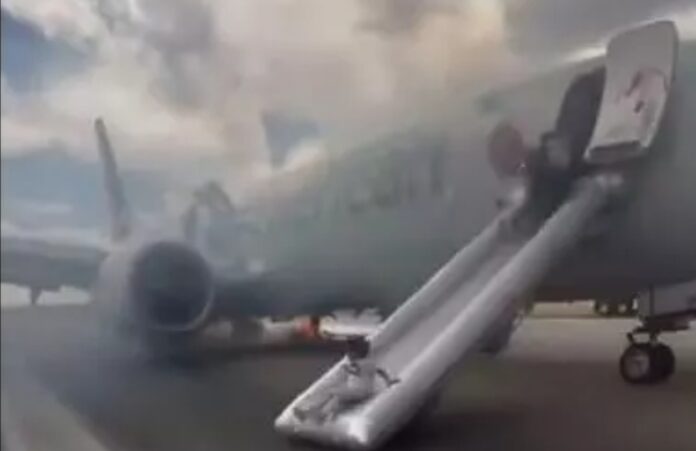 Watch: Passengers evacuate American Airlines flight over fire